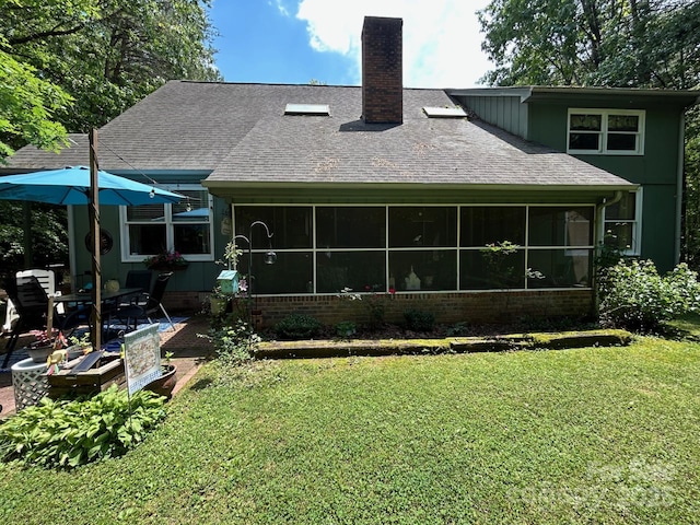 2815 Penny Park Dr, Gastonia, NC 28052 - rear view of property with a sunroom, a chimney, a yard, a patio, and roof with shingles