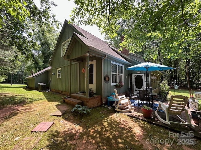 2815 Penny Park Dr, Gastonia, NC 28052 - rear view of property featuring roof with shingles, a yard, a patio area, central air condition unit, and board and batten siding