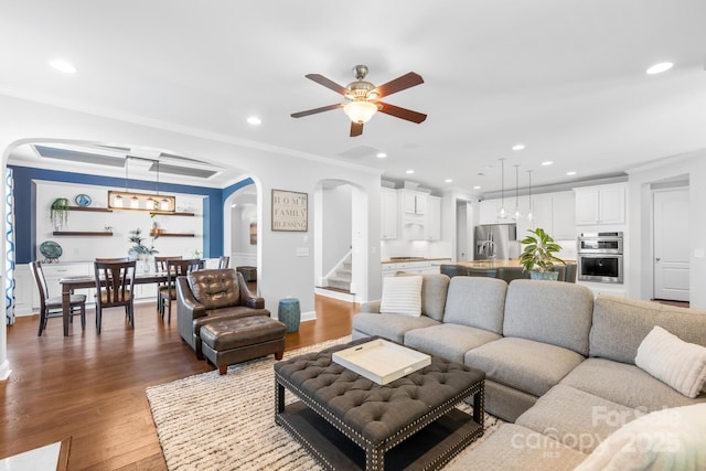 3918 Halcyon Dr, Huntersville, NC 28078 - living room with arched walkways, ceiling fan, recessed lighting, crown molding, and wood finished floors