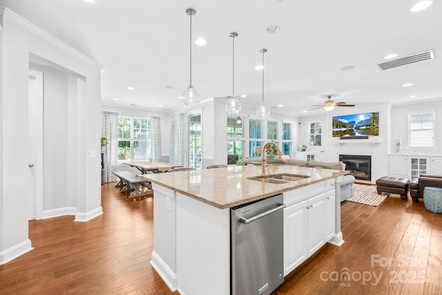 3918 Halcyon Dr, Huntersville, NC 28078 - kitchen featuring a sink, open floor plan, a glass covered fireplace, ornamental molding, and a ceiling fan