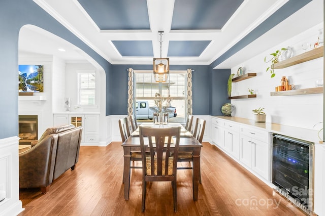 3918 Halcyon Dr, Huntersville, NC 28078 - dining room featuring beverage cooler, coffered ceiling, ornamental molding, a dry bar, and a decorative wall