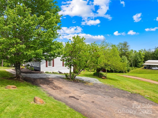 16 Julep Dr, Alexander, NC 28701 - obstructed view of property with a front lawn and dirt driveway