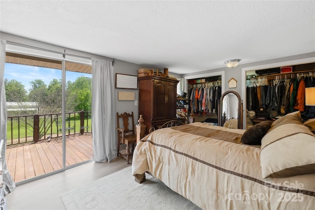 16 Julep Dr, Alexander, NC 28701 - bedroom featuring access to outside, two closets, a textured ceiling, and concrete floors