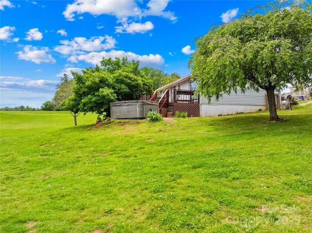 16 Julep Dr, Alexander, NC 28701 - view of green lawn featuring a hot tub and a wooden deck
