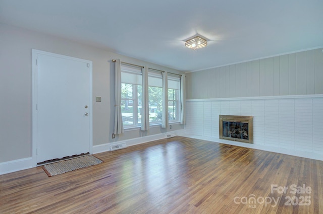 3951 Whitehall Dr, Charlotte, NC 28208 - unfurnished living room with wood finished floors, a fireplace, and baseboards