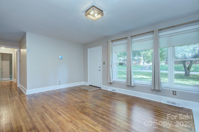 3951 Whitehall Dr, Charlotte, NC 28208 - empty room with healthy amount of natural light, wood finished floors, and baseboards