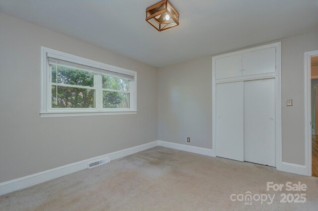 3951 Whitehall Dr, Charlotte, NC 28208 - unfurnished bedroom with baseboards, carpet, and a closet