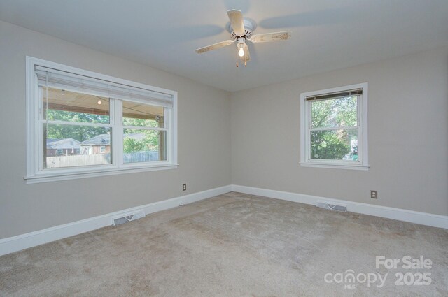 3951 Whitehall Dr, Charlotte, NC 28208 - carpeted empty room with healthy amount of natural light, baseboards, and ceiling fan
