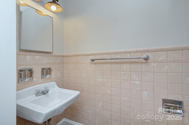3951 Whitehall Dr, Charlotte, NC 28208 - bathroom with a sink, tile walls, and wainscoting