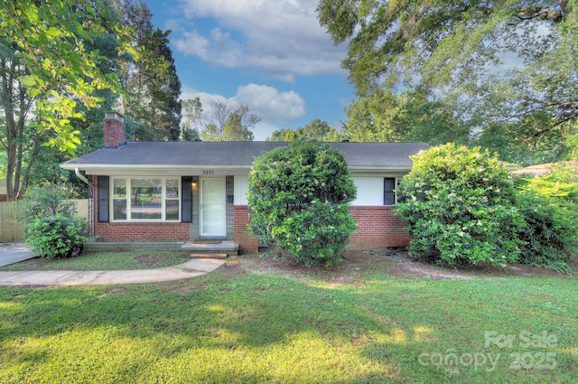 3951 Whitehall Dr, Charlotte, NC 28208 - view of front of home with brick siding, a front yard, and a chimney