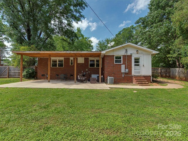 3951 Whitehall Dr, Charlotte, NC 28208 - rear view of house featuring central AC unit, brick siding, entry steps, a patio, and crawl space