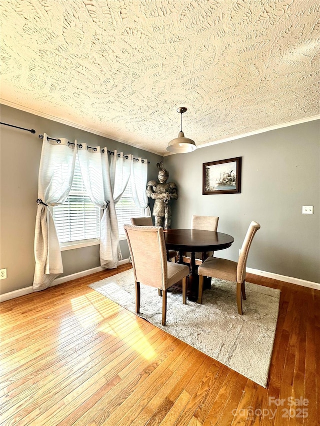 49 Perseverance Dr, Canton, NC 28716 - dining room with a textured ceiling, hardwood / wood-style flooring, baseboards, and ornamental molding