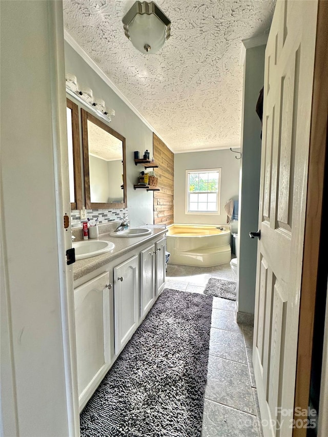 49 Perseverance Dr, Canton, NC 28716 - bathroom featuring a textured ceiling, ornamental molding, a bath, double vanity, and tasteful backsplash