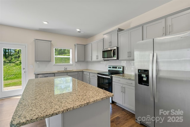 383 Ridgeview Ln, Mars Hill, NC 28754 - kitchen with appliances with stainless steel finishes, gray cabinets, a kitchen island, light stone countertops, and backsplash