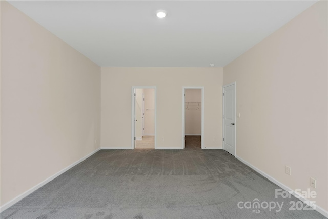 383 Ridgeview Ln, Mars Hill, NC 28754 - unfurnished bedroom featuring carpet flooring, a walk in closet, baseboards, and a closet