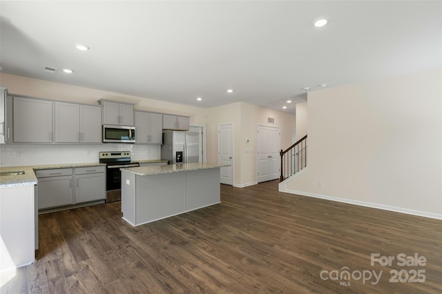 383 Ridgeview Ln, Mars Hill, NC 28754 - kitchen with appliances with stainless steel finishes, gray cabinets, a kitchen island, decorative backsplash, and dark wood-style floors