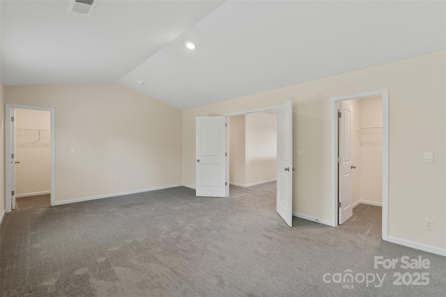 383 Ridgeview Ln, Mars Hill, NC 28754 - unfurnished bedroom with a spacious closet, a closet, lofted ceiling, carpet, and baseboards