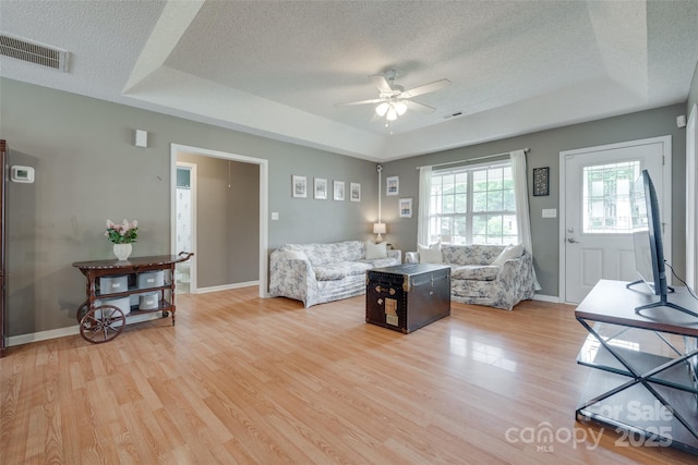 2023 E Park Dr, Lancaster, SC 29720 - living area featuring a tray ceiling, ceiling fan, light wood-style flooring, a textured ceiling, and baseboards