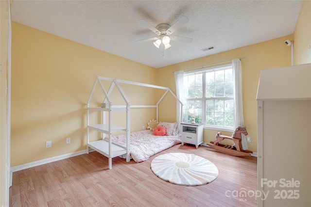 2023 E Park Dr, Lancaster, SC 29720 - bedroom with wood finished floors, a textured ceiling, baseboards, and a ceiling fan
