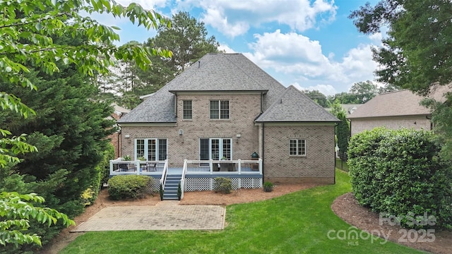 6132 Sharon Rd, Charlotte, NC 28210 - back of house featuring brick siding, a patio area, a lawn, a deck, and roof with shingles