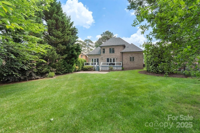 6132 Sharon Rd, Charlotte, NC 28210 - back of house with a yard, brick siding, and a deck