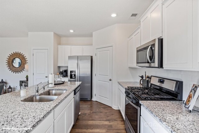3735 13th St NE, Hickory, NC 28601 - kitchen with appliances with stainless steel finishes, a sink, white cabinets, dark wood-style flooring, and light stone counters