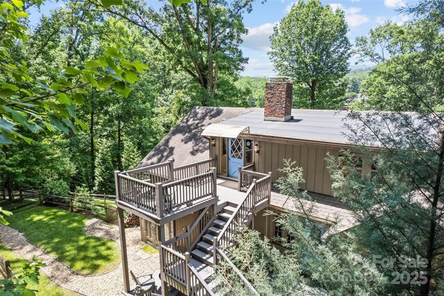 66 Fox Trot Ln, Tryon, NC 28782 - back of property featuring a deck, a chimney, stairs, and board and batten siding