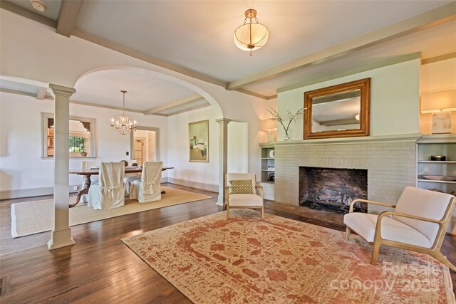 66 Fox Trot Ln, Tryon, NC 28782 - living area with arched walkways, decorative columns, wood finished floors, and beamed ceiling