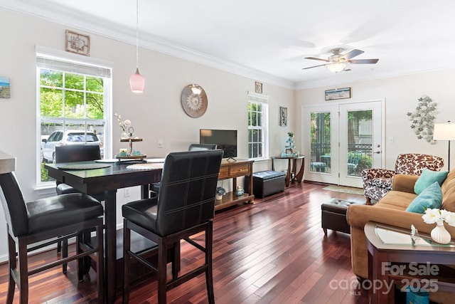 dining room featuring ceiling fan, healthy amount of natural light, dark wood-type flooring, and crown molding