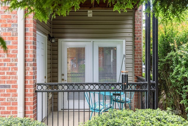 entrance to property featuring brick siding