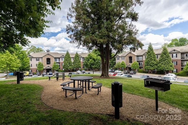 view of home's community with a residential view and a lawn