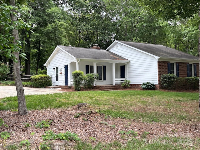 7212 Bradley Ct, Charlotte, NC 28227 - ranch-style house featuring covered porch, a front lawn, roof with shingles, a chimney, and view of scattered trees