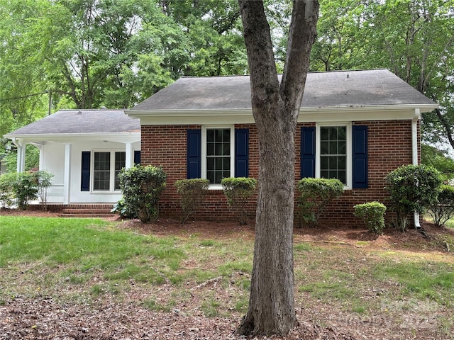 7212 Bradley Ct, Charlotte, NC 28227 - view of front facade with brick siding, a front yard, and a shingled roof