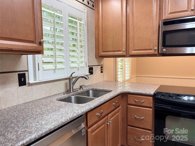 7212 Bradley Ct, Charlotte, NC 28227 - kitchen with appliances with stainless steel finishes, a sink, backsplash, and brown cabinets