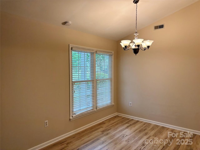 7212 Bradley Ct, Charlotte, NC 28227 - unfurnished room with light wood-type flooring, vaulted ceiling, a chandelier, baseboards, and a smoke detector