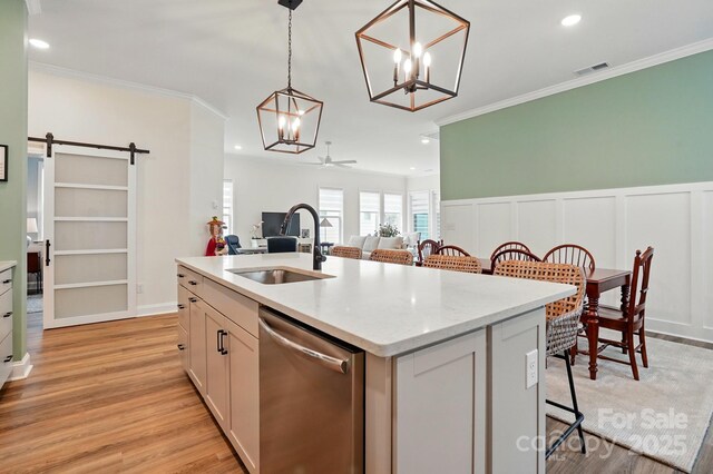 1318 Encore Ln, Waxhaw, NC 28173 - kitchen with dishwasher, a sink, crown molding, a barn door, and a kitchen breakfast bar