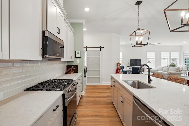 1318 Encore Ln, Waxhaw, NC 28173 - kitchen featuring stainless steel appliances, a sink, ornamental molding, recessed lighting, and tasteful backsplash