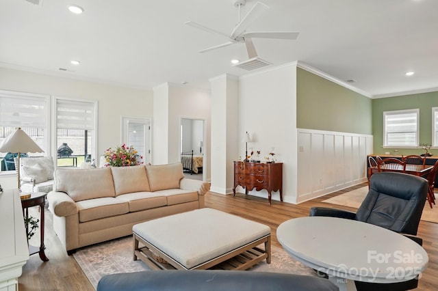 1318 Encore Ln, Waxhaw, NC 28173 - living area featuring crown molding, plenty of natural light, wood finished floors, a ceiling fan, and a wainscoted wall