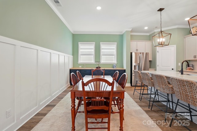 1318 Encore Ln, Waxhaw, NC 28173 - dining area featuring crown molding, a chandelier, recessed lighting, and dark wood-style flooring