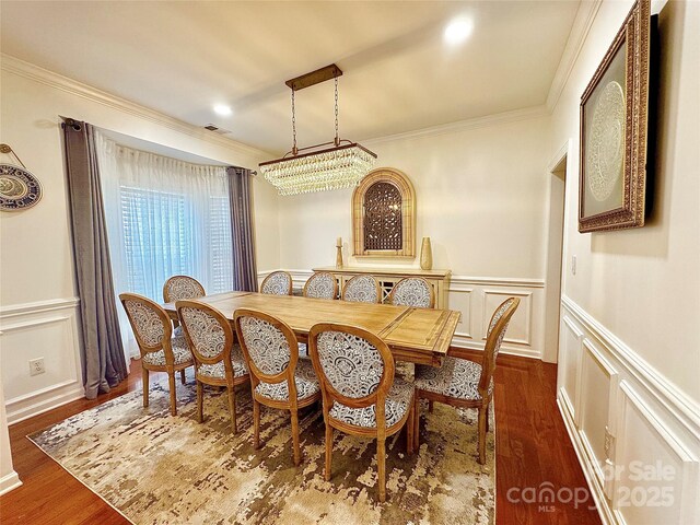 16012 Caranna Ct, Charlotte, NC 28277 - dining space with a decorative wall, ornamental molding, a wainscoted wall, and dark wood-type flooring