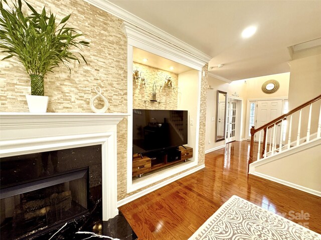 16012 Caranna Ct, Charlotte, NC 28277 - living room featuring crown molding, a fireplace, wood finished floors, baseboards, and stairs