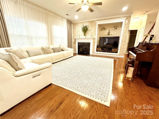 16012 Caranna Ct, Charlotte, NC 28277 - living room with a ceiling fan, wood finished floors, a fireplace with flush hearth, and ornamental molding