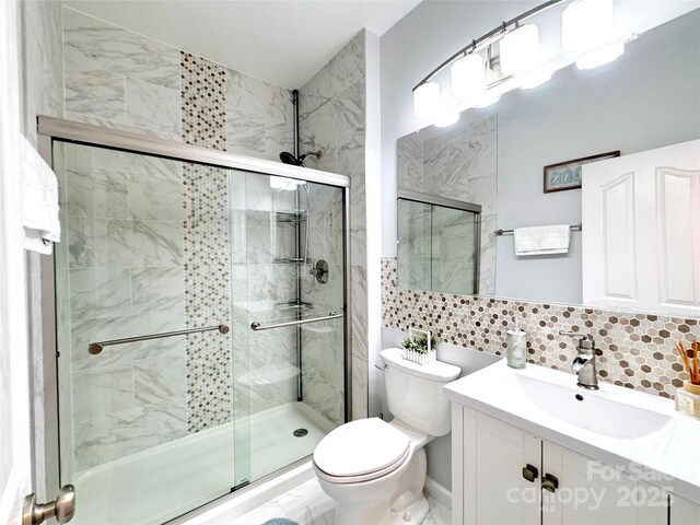 16012 Caranna Ct, Charlotte, NC 28277 - full bath featuring a shower stall, toilet, vanity, backsplash, and tile walls