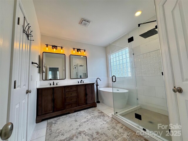 16012 Caranna Ct, Charlotte, NC 28277 - full bath featuring a stall shower, a freestanding tub, double vanity, and tile patterned flooring