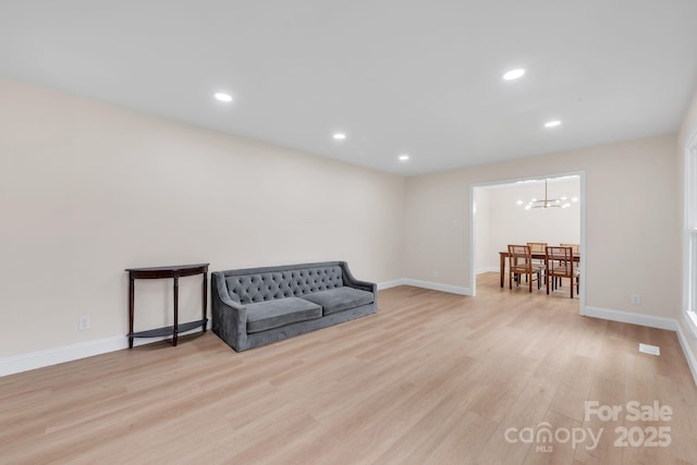 6641 Pawnee Dr, Charlotte, NC 28214 - sitting room with light wood-style flooring, recessed lighting, baseboards, and a chandelier