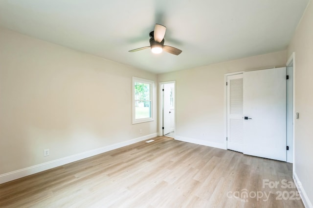 6641 Pawnee Dr, Charlotte, NC 28214 - unfurnished bedroom featuring light wood-type flooring, baseboards, a closet, and a ceiling fan