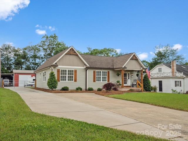 107 Pressley St, Clover, SC 29710 - ranch-style home with an outbuilding, board and batten siding, concrete driveway, a front yard, and roof with shingles