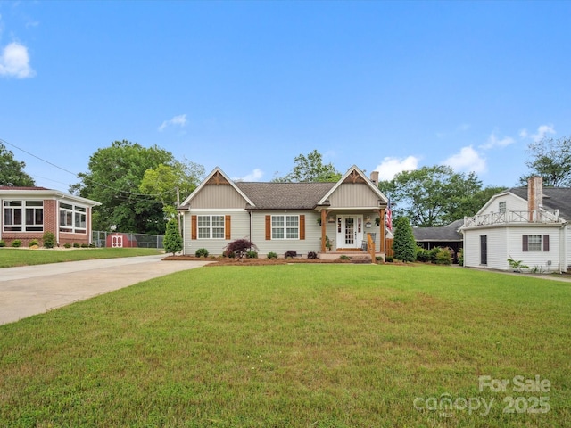 107 Pressley St, Clover, SC 29710 - view of front facade featuring concrete driveway, a front lawn, a chimney, and board and batten siding