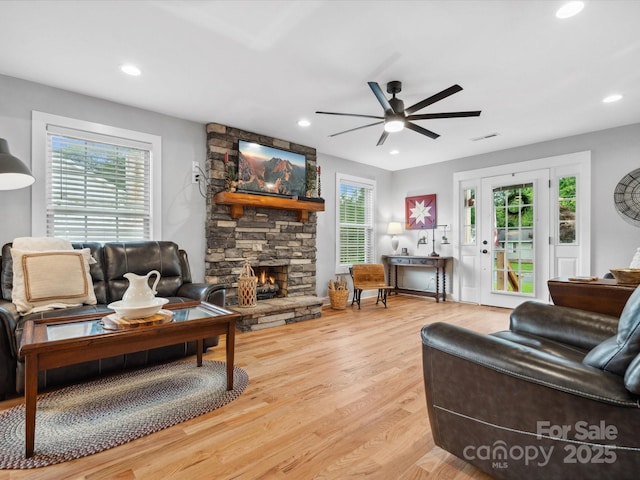 107 Pressley St, Clover, SC 29710 - living room featuring healthy amount of natural light, a stone fireplace, ceiling fan, light wood finished floors, and recessed lighting
