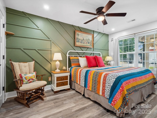 107 Pressley St, Clover, SC 29710 - bedroom featuring wood finished floors, recessed lighting, ceiling fan, baseboards, and a decorative wall